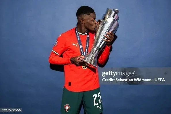 Nuno Mendes holding the UEFA Nations League trophy