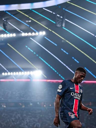 Nuno Mendes in Paris Saint-Germain colours under stadium lights