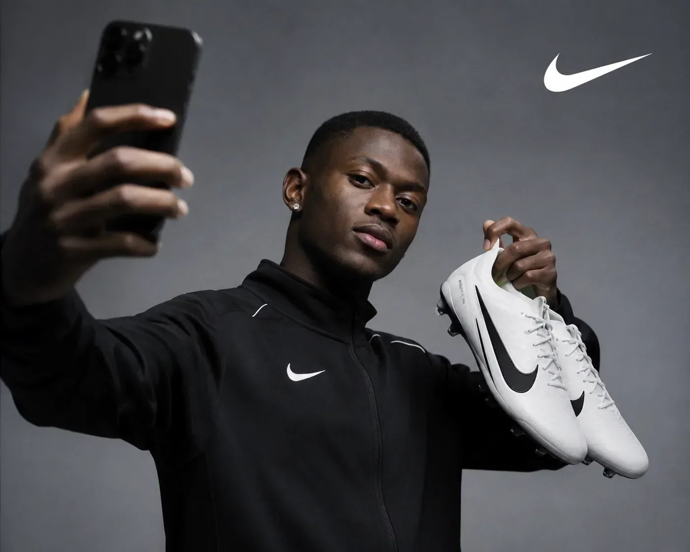 Nuno Mendes holding Nike football boots